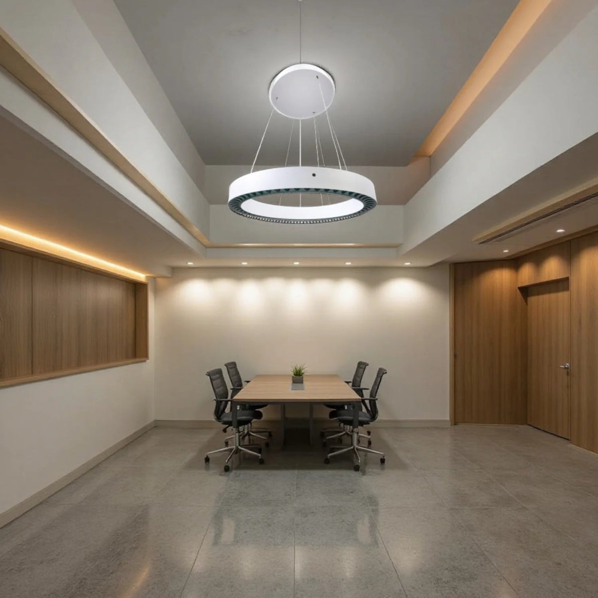 Modern conference room with a chandelier, table, and chairs.