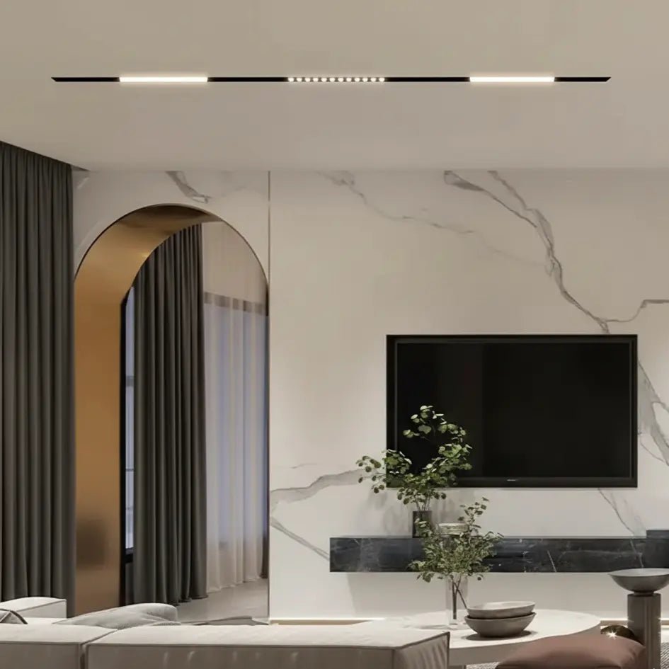 Modern living room with a marble wall, TV, and decorative elements.