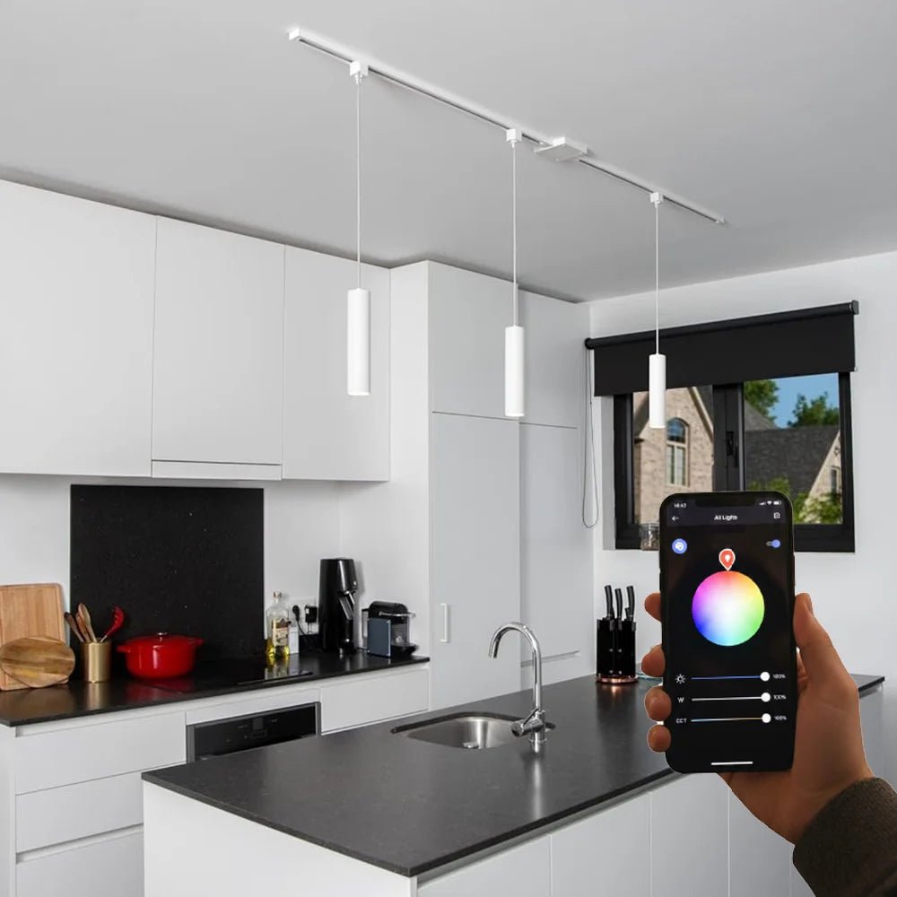 Person using a smartphone app to control kitchen lighting in a modern kitchen.
