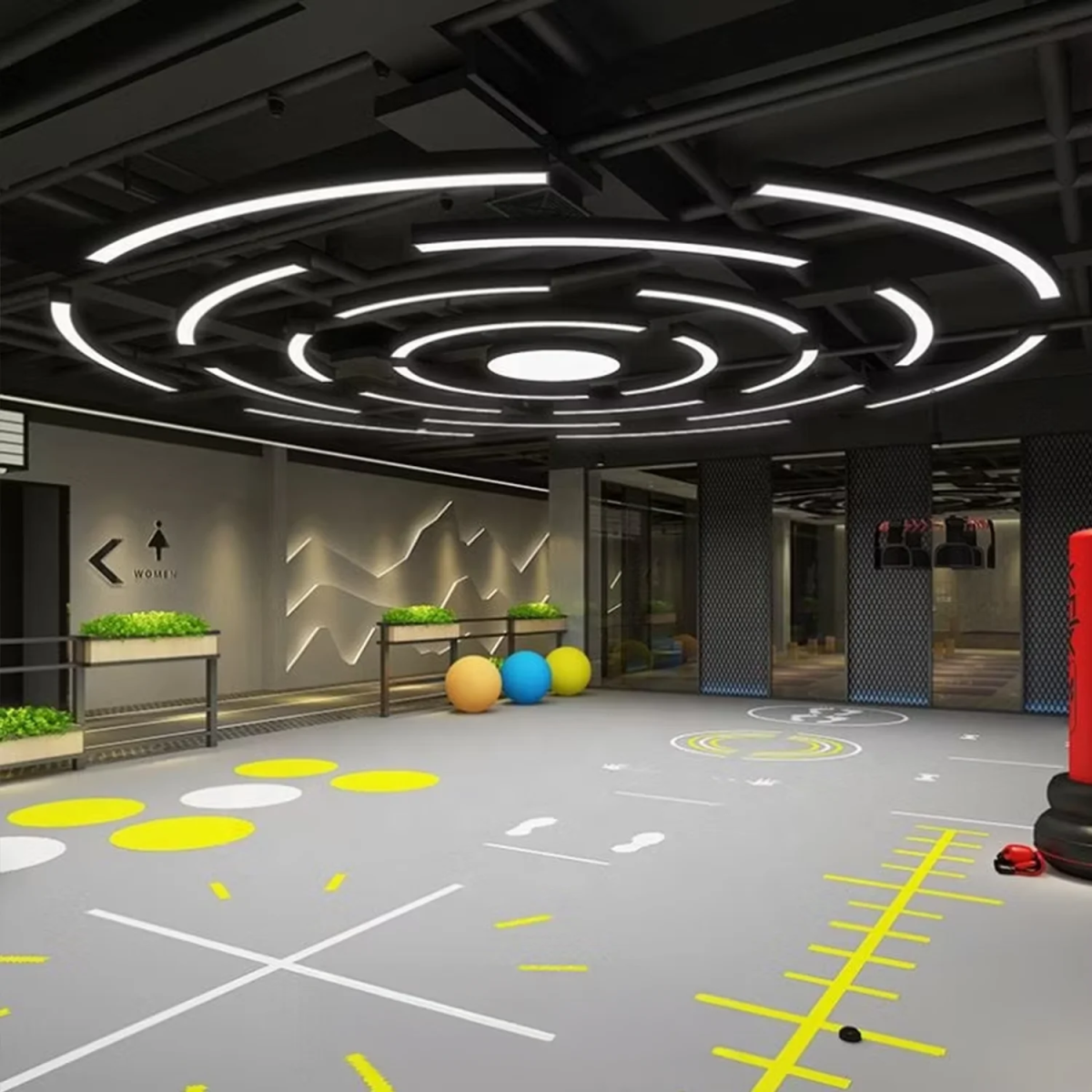 Modern indoor space with geometric ceiling design and colorful balls on the floor