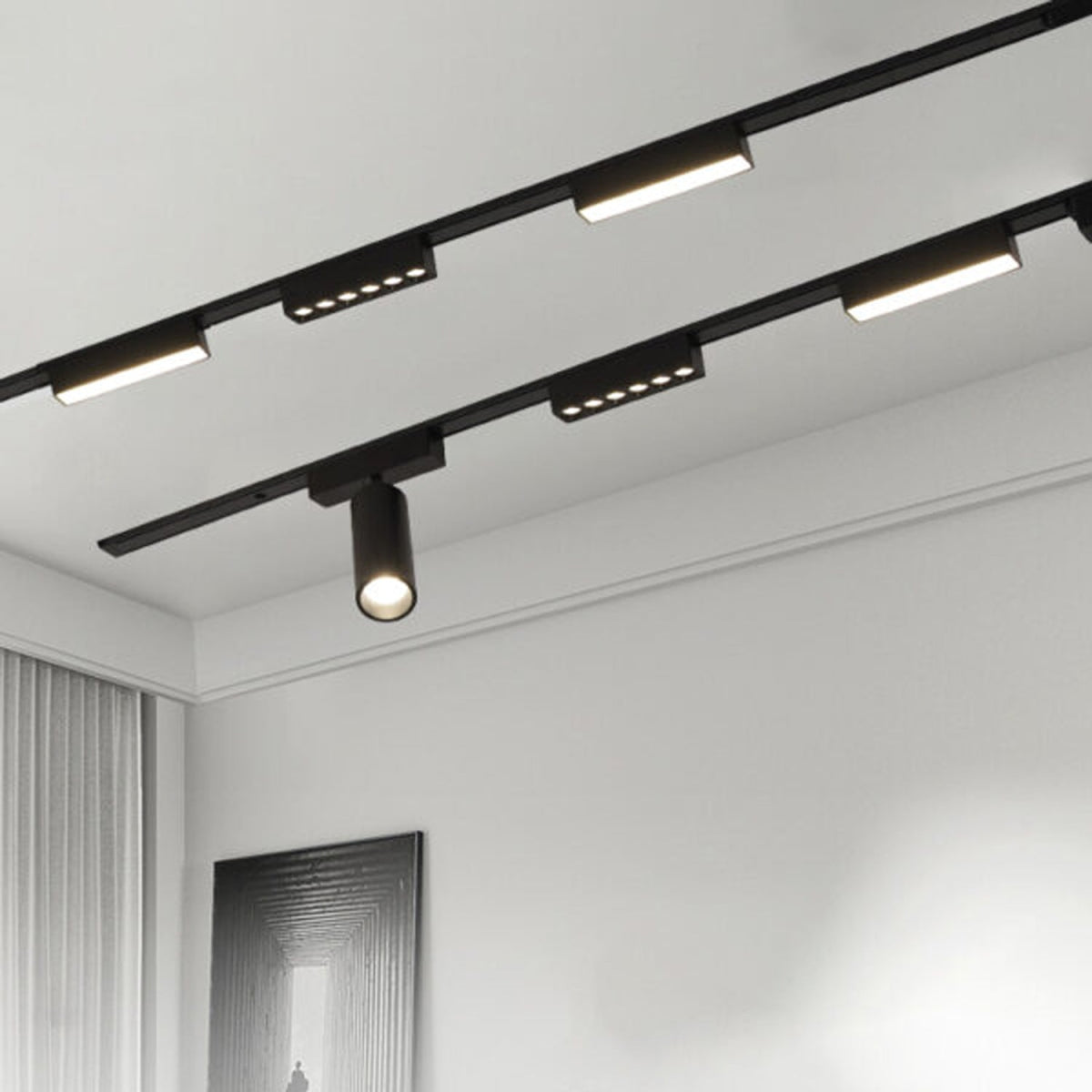 Track lighting system on a ceiling with multiple lights on a white wall background