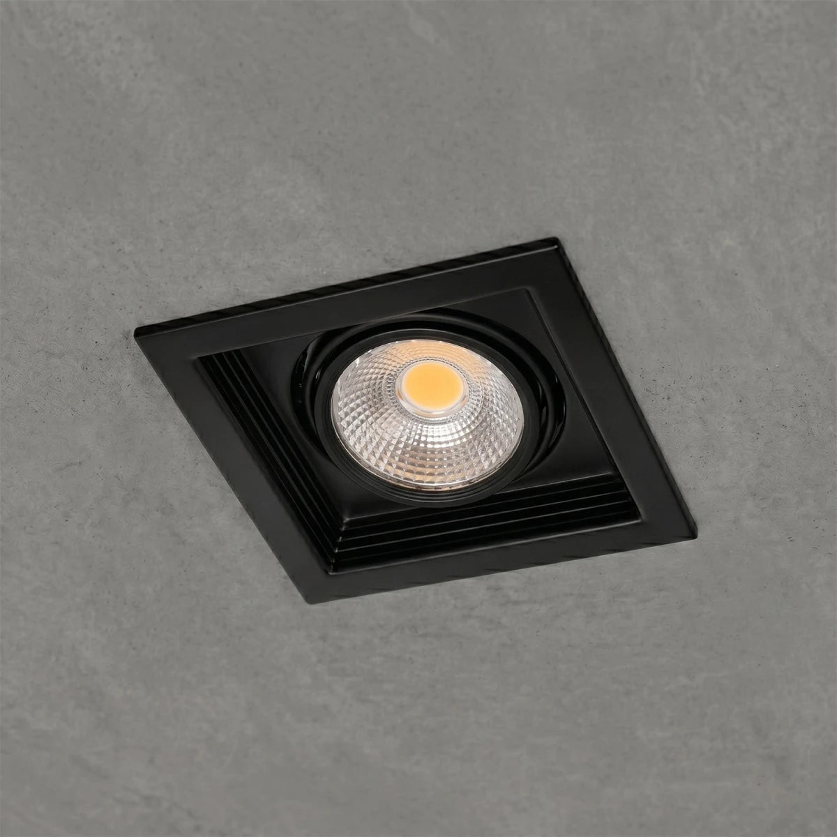 Black square recessed ceiling light on a gray background
