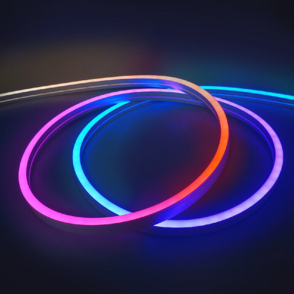 Neon glow sticks in red, blue, and pink on a dark background