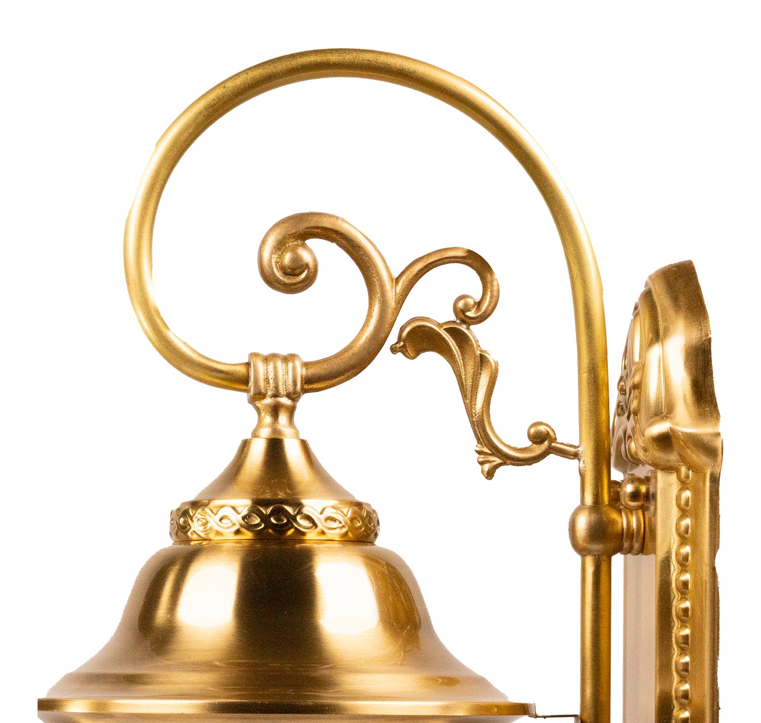 Close-up of a gold bell with decorative arm on a white background