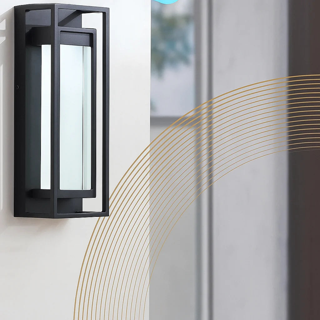 Black outdoor wall light fixture on a white wall with decorative gold lines.