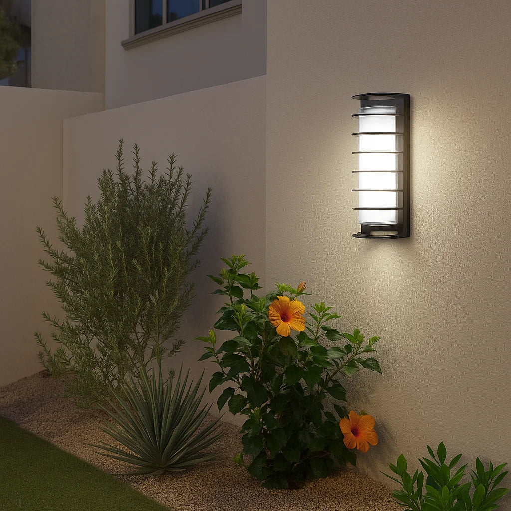 Garden wall light fixture on a wall with plants and flowers below
