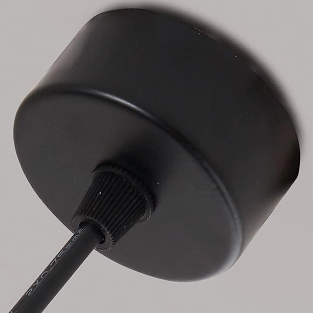 Black cylindrical device with a cable on a gray background