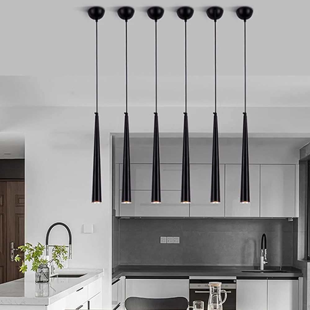 Modern kitchen with black pendant lights hanging from the ceiling.