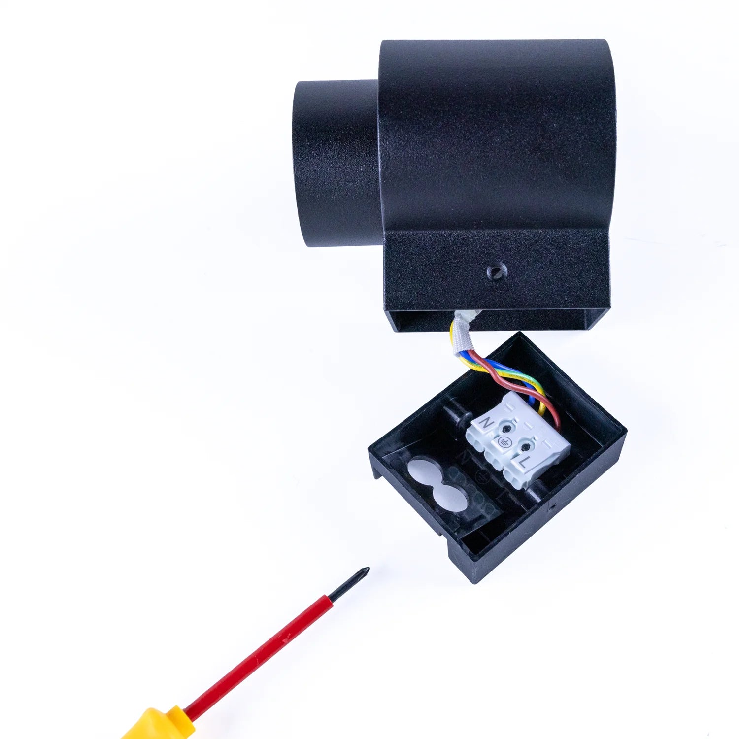 Black electronic device with wiring and a screwdriver on a white background