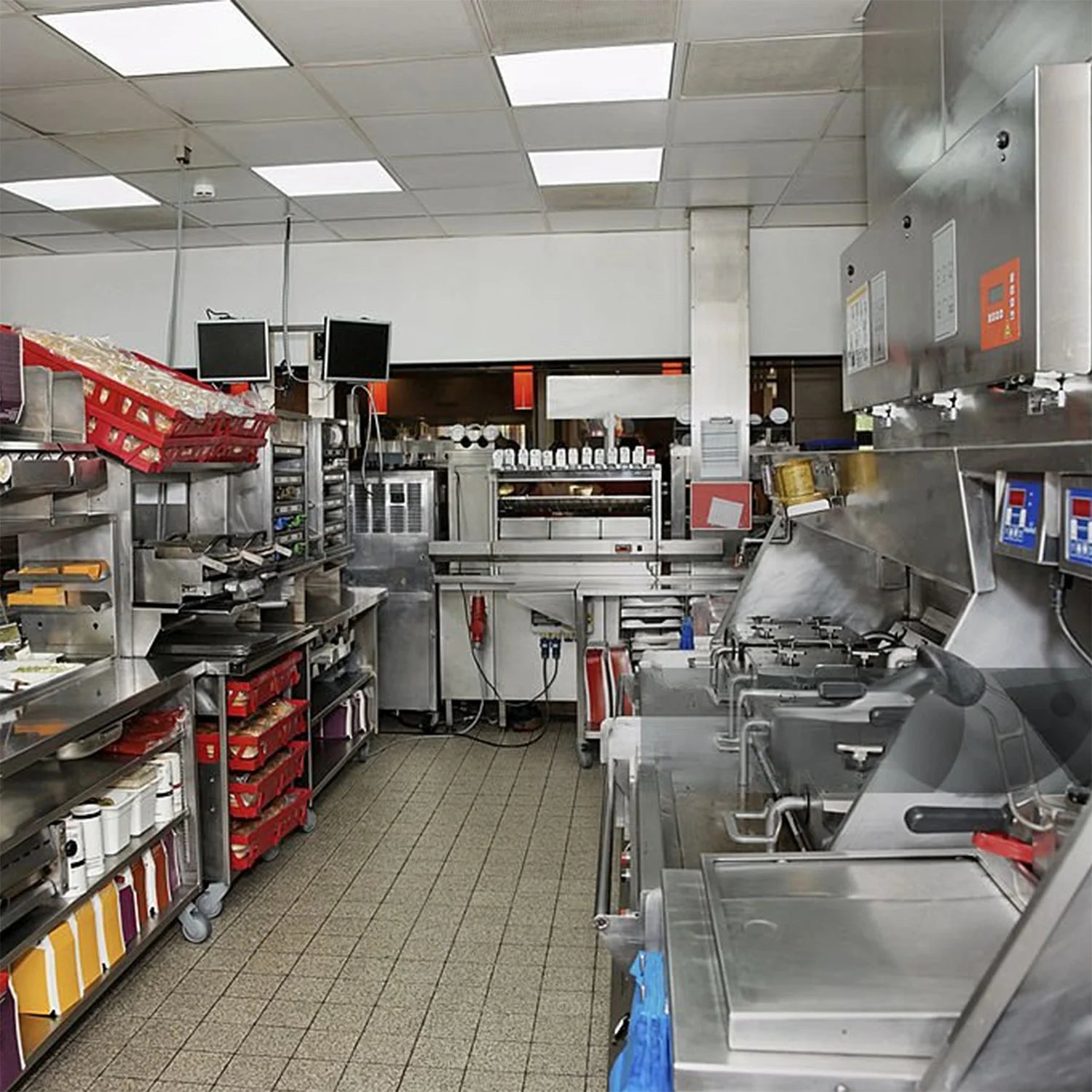 Commercial kitchen with stainless steel appliances and equipment.