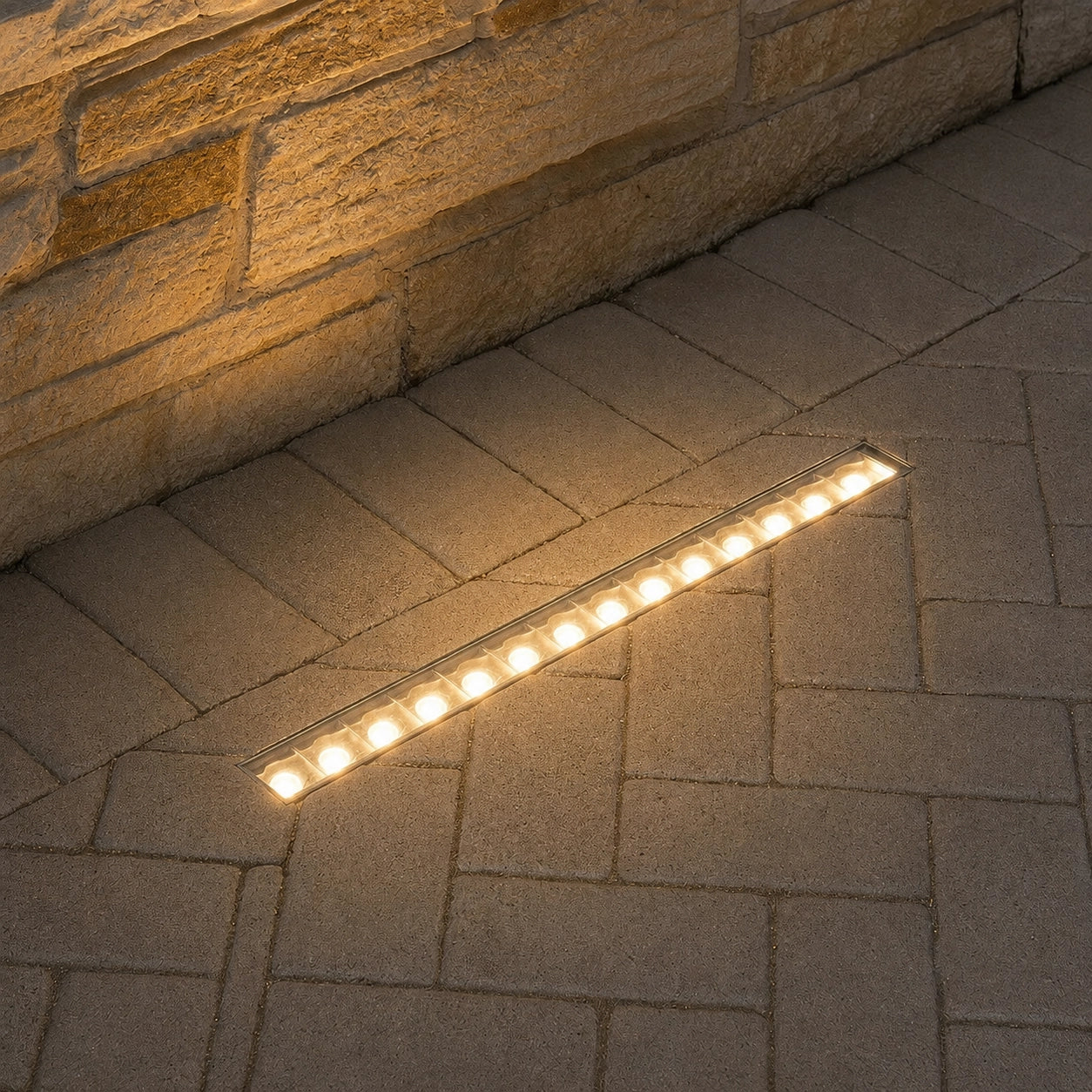LED strip light on a stone patio next to a stone wall