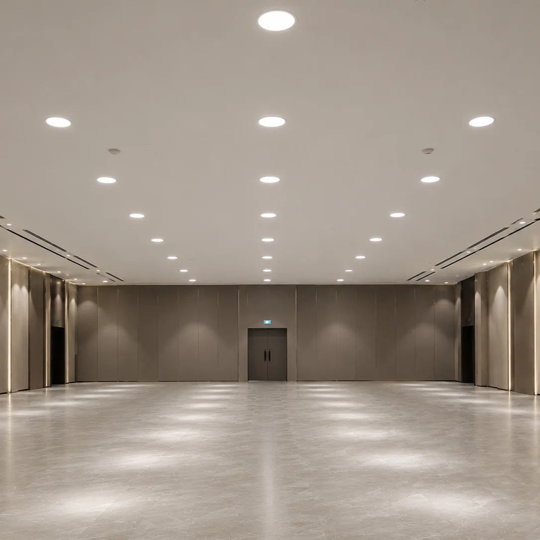 Large empty room with beige walls and a polished concrete floor.