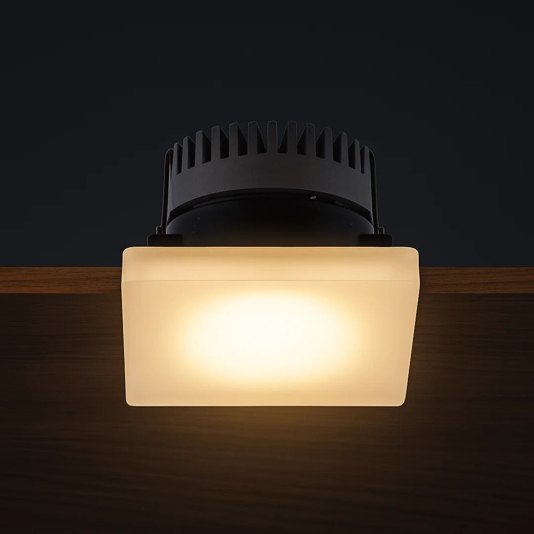 Square ceiling light fixture with frosted glass cover on a dark background