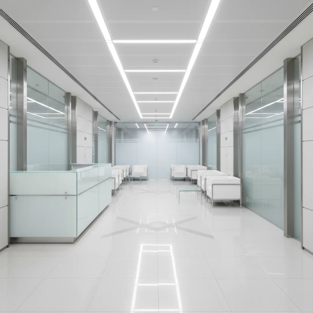 Modern office hallway with glass partitions and white furniture