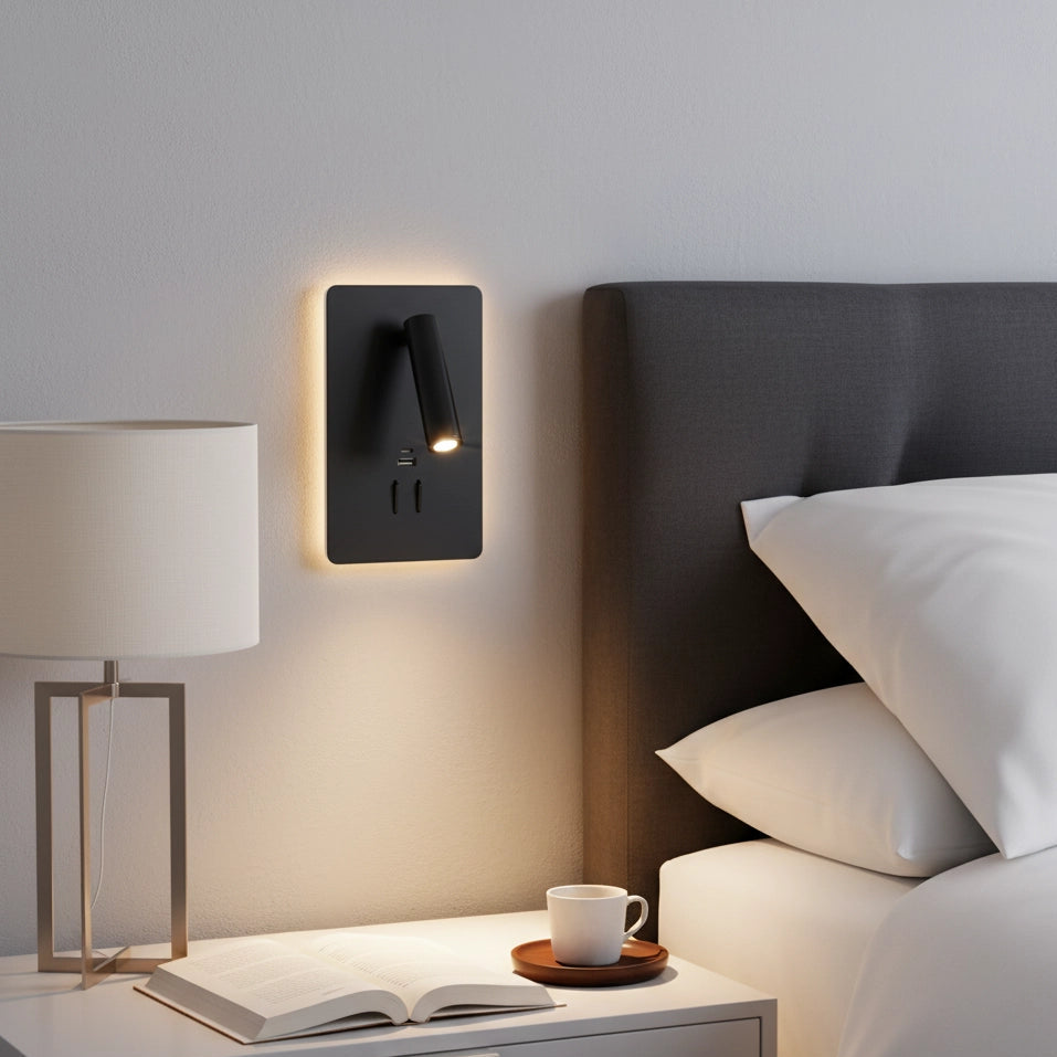 Modern wall-mounted light fixture on a bedroom wall with a nightstand and bed in the foreground.