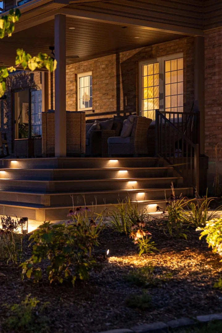 Outdoor patio area with lighting fixtures on a house exterior
