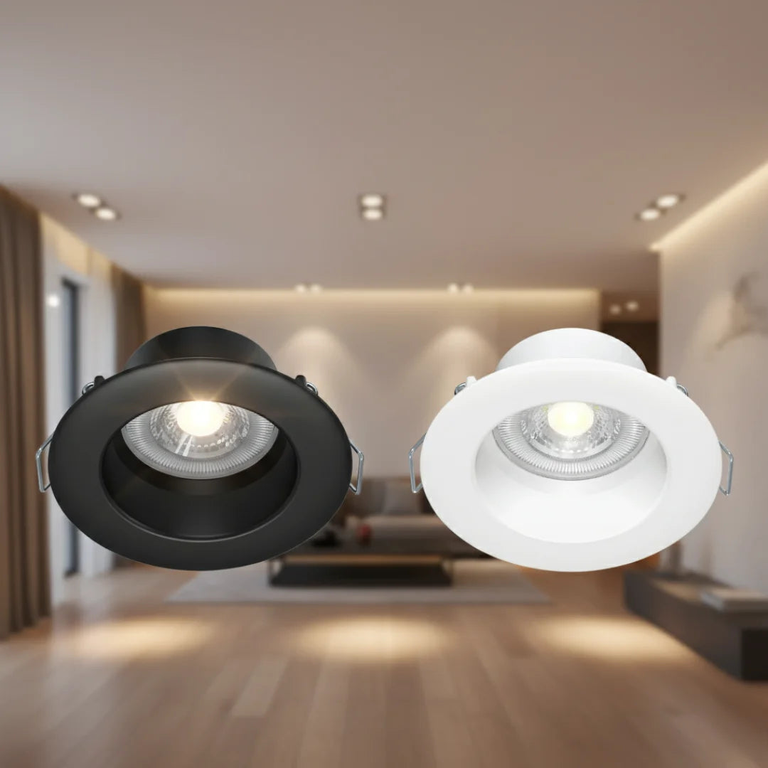 Two recessed ceiling lights, one black and one white, in a modern interior setting.