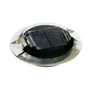 A solar-powered ground embedded light with a visible solar panel on top.