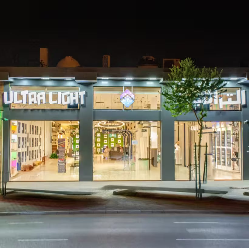 Storefront with 'Ultra Light' sign at night