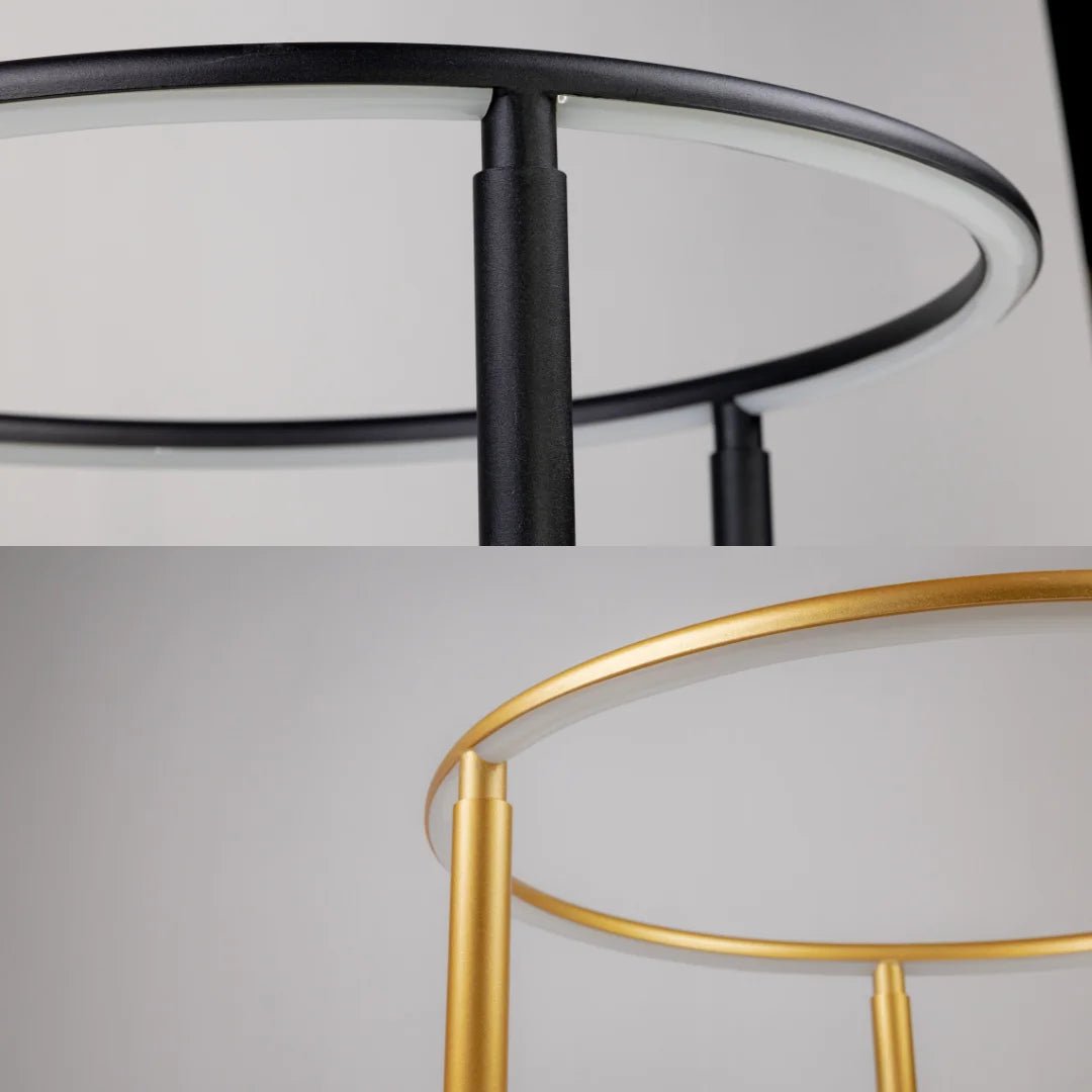 Close-up of black and gold circular lampshades on a light gray background