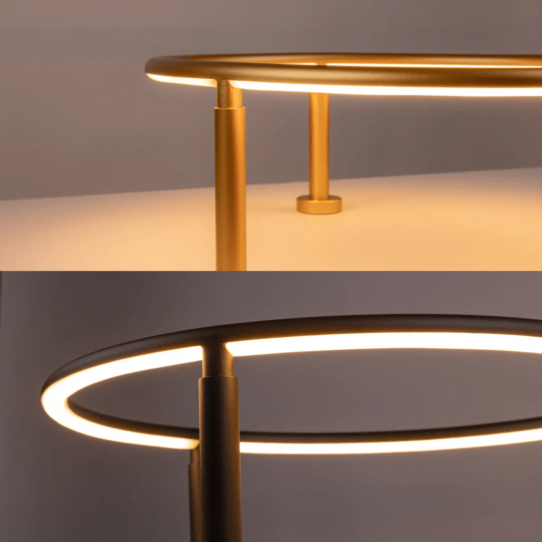 Two modern side tables with gold and black finishes on a neutral background
