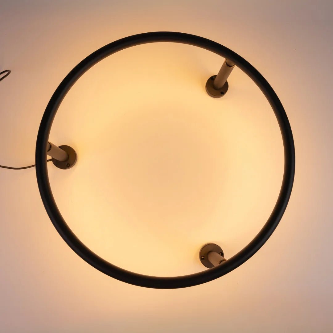 Ceiling light fixture with a circular design on a plain background