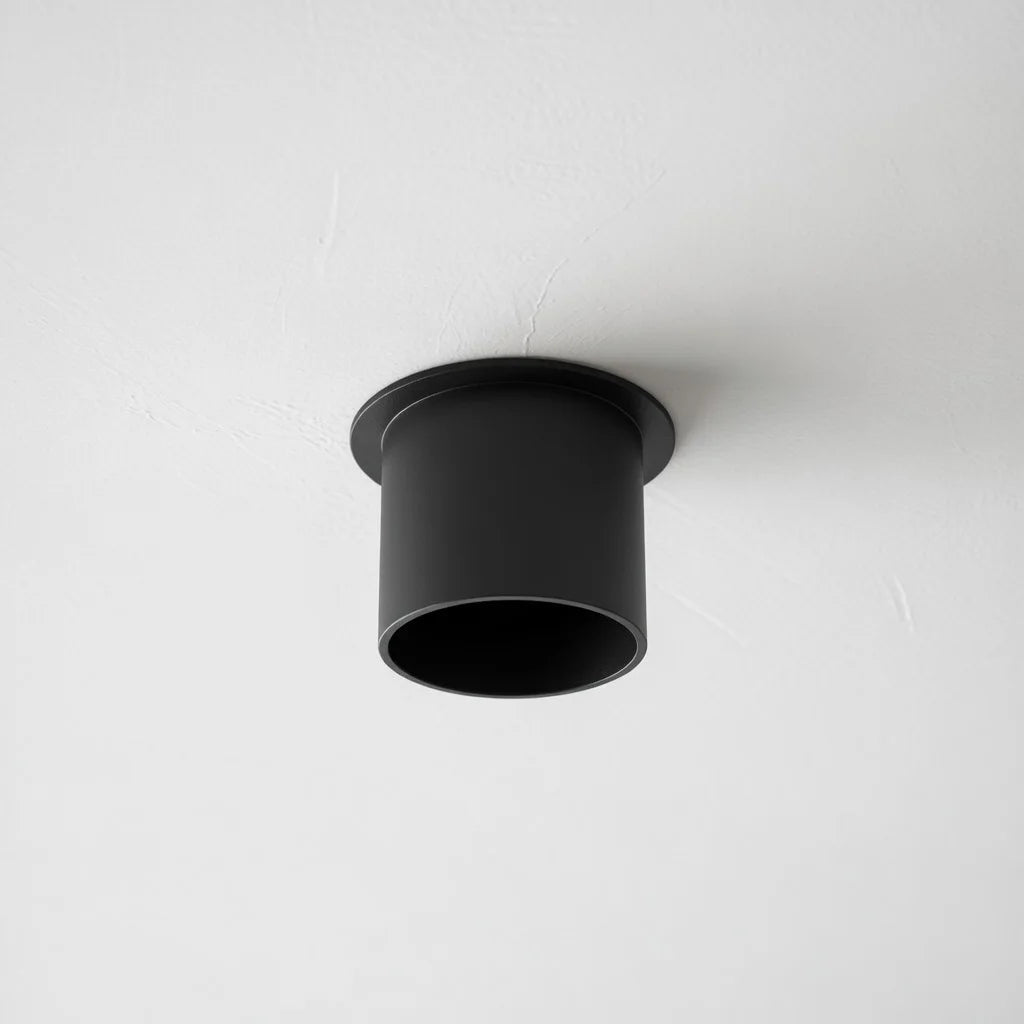 Black ceiling light fixture on a white ceiling