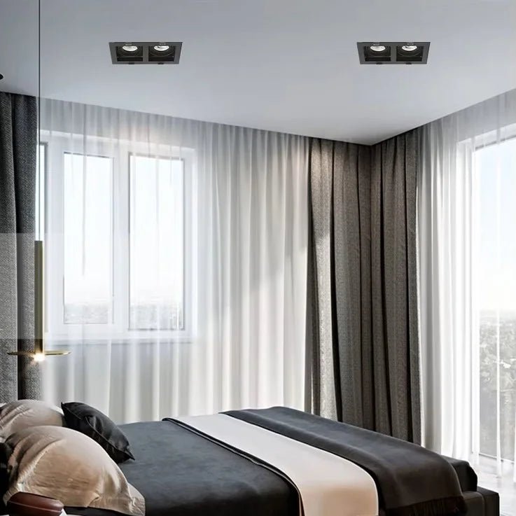 Modern bedroom with a bed, curtains, and large windows.