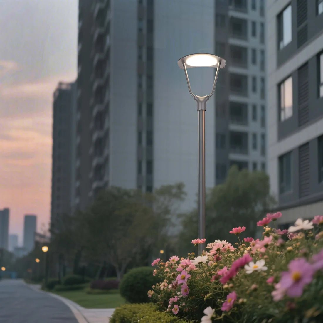 Street lamp with flowers in front of tall buildings during dusk.