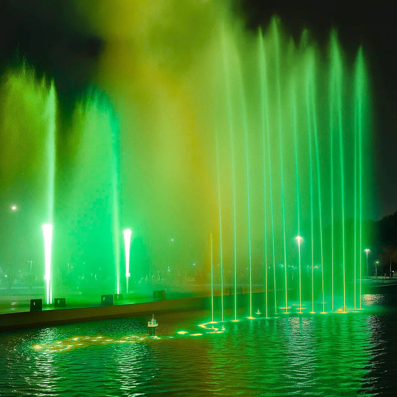 Fountain show with green lights at night
