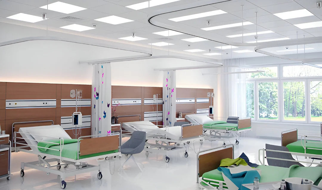 Modern hospital room with patient beds and medical equipment.