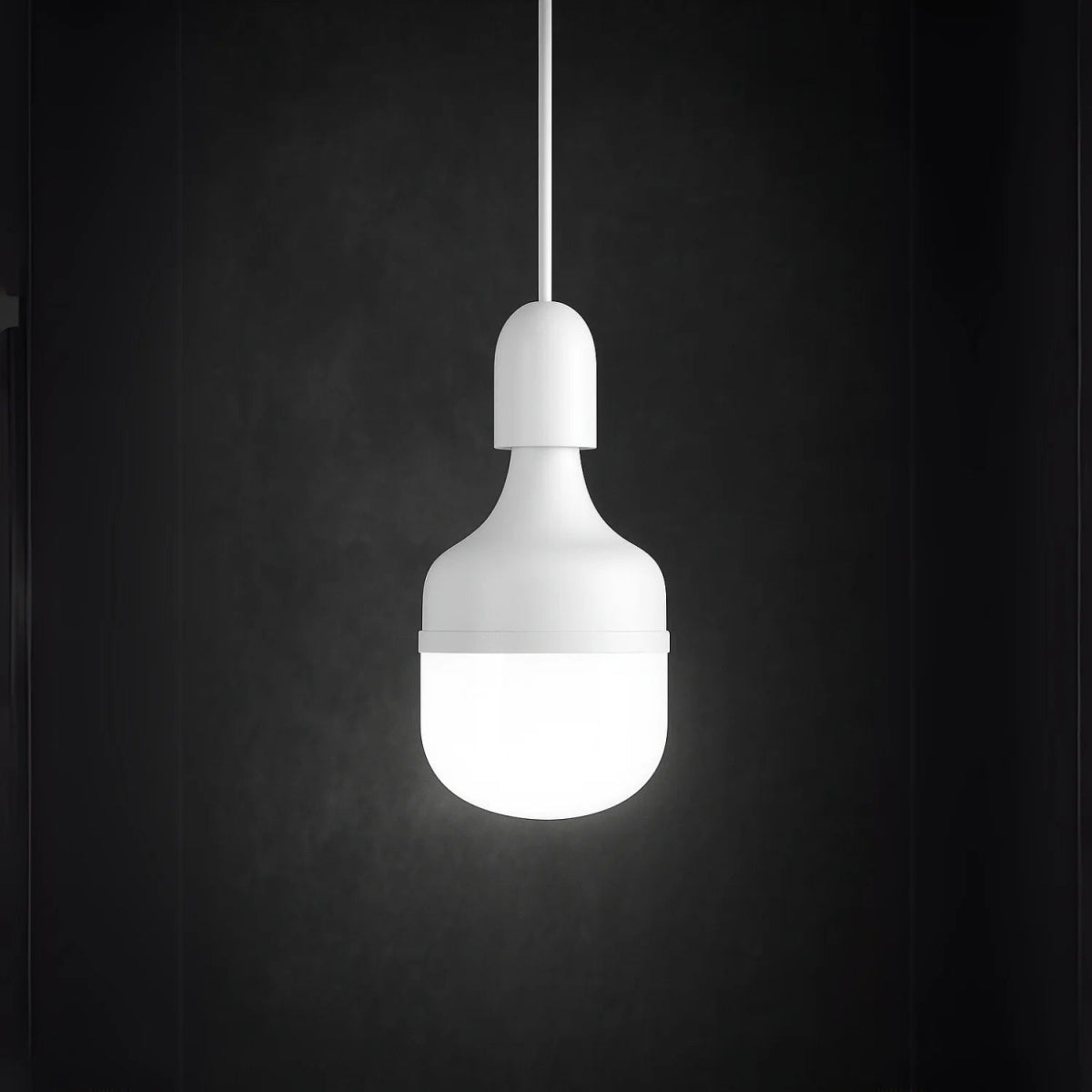 White pendant light bulb on a black background