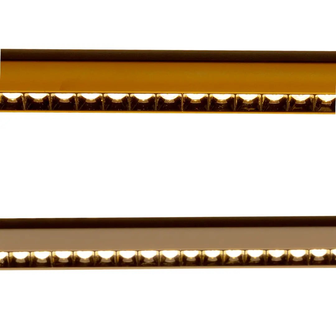 Close-up of a gold and bronze strip with decorative patterns on a white background