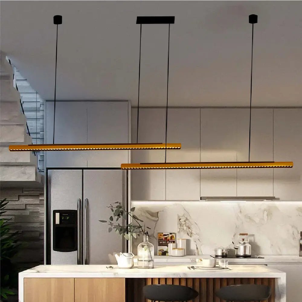 Modern kitchen with pendant lights and a marble countertop.