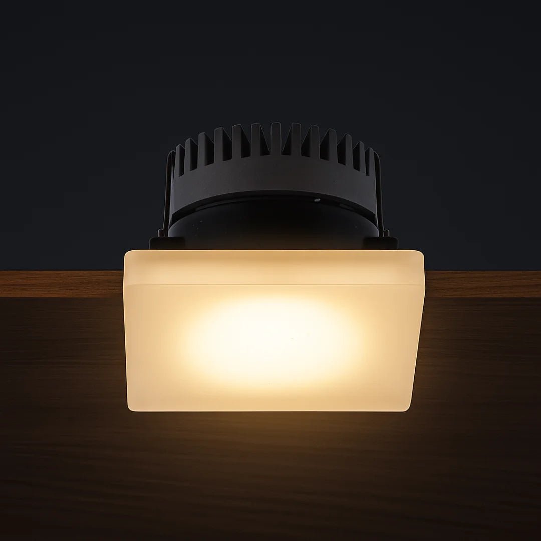 Square ceiling light fixture with frosted glass cover on a dark background