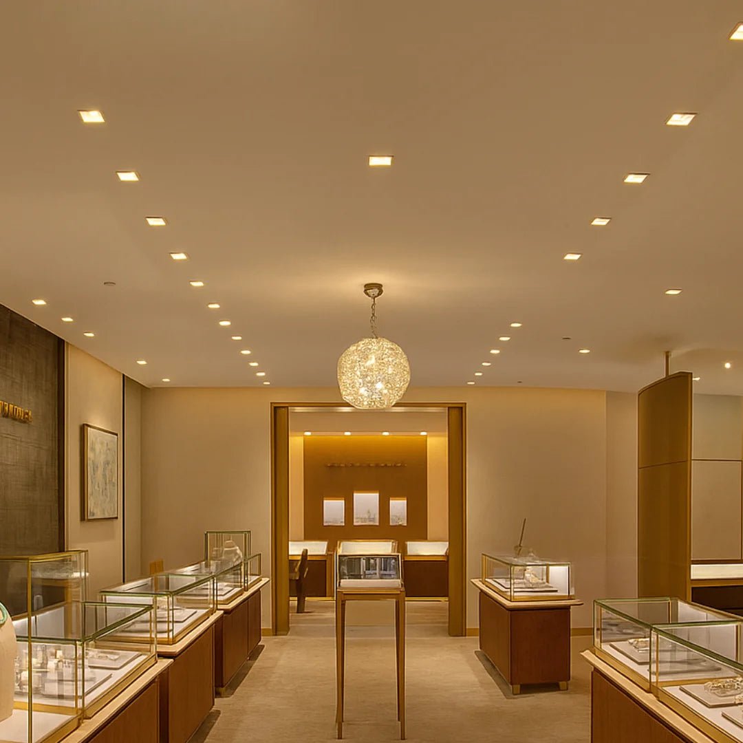 Luxury jewelry store interior with display cases and a chandelier.