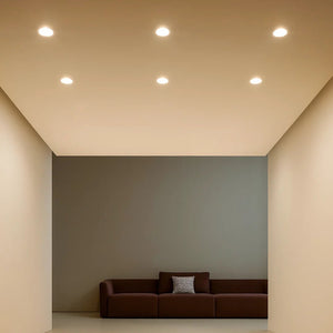 Modern living room with a brown sofa against a gray wall.
