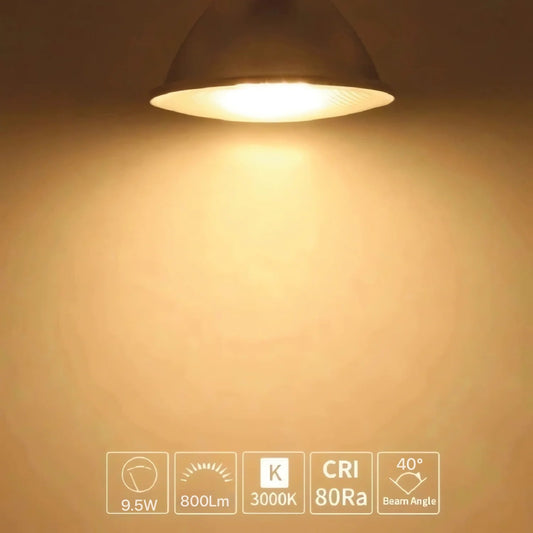 Light fixture emitting a warm glow on a beige wall with technical specifications displayed.