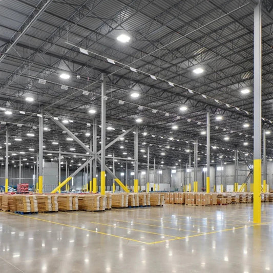 Large warehouse interior with high ceilings and rows of stacked pallets.