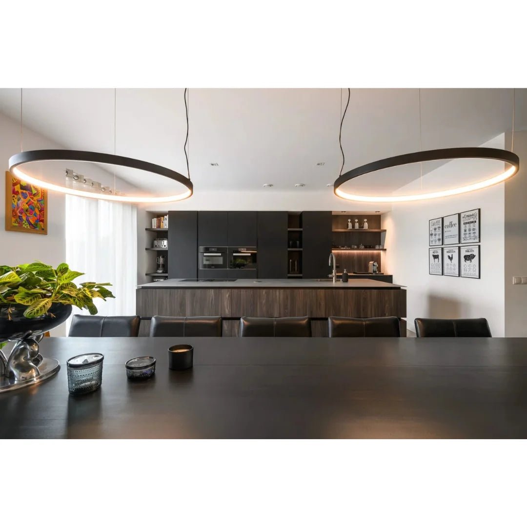 Modern kitchen with pendant lights, dining table, and chairs.