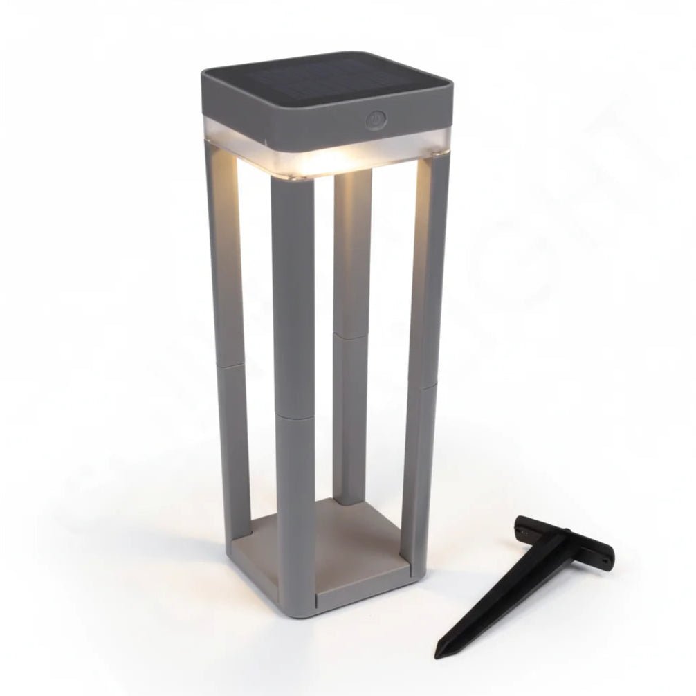 Solar-powered outdoor lamp with a black stake on a white background
