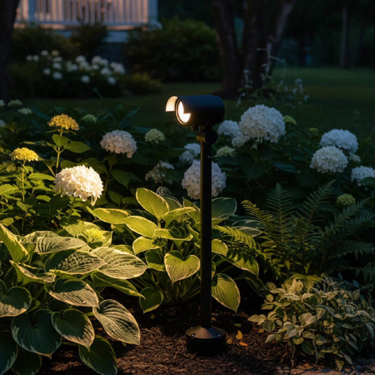 Garden light illuminating flowers and plants in a garden setting