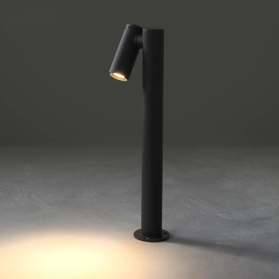 Black outdoor lamp post with a single light fixture on a dark gray background