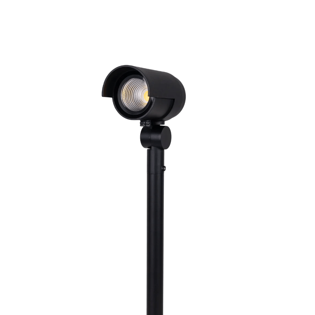 Black outdoor light fixture on a green background