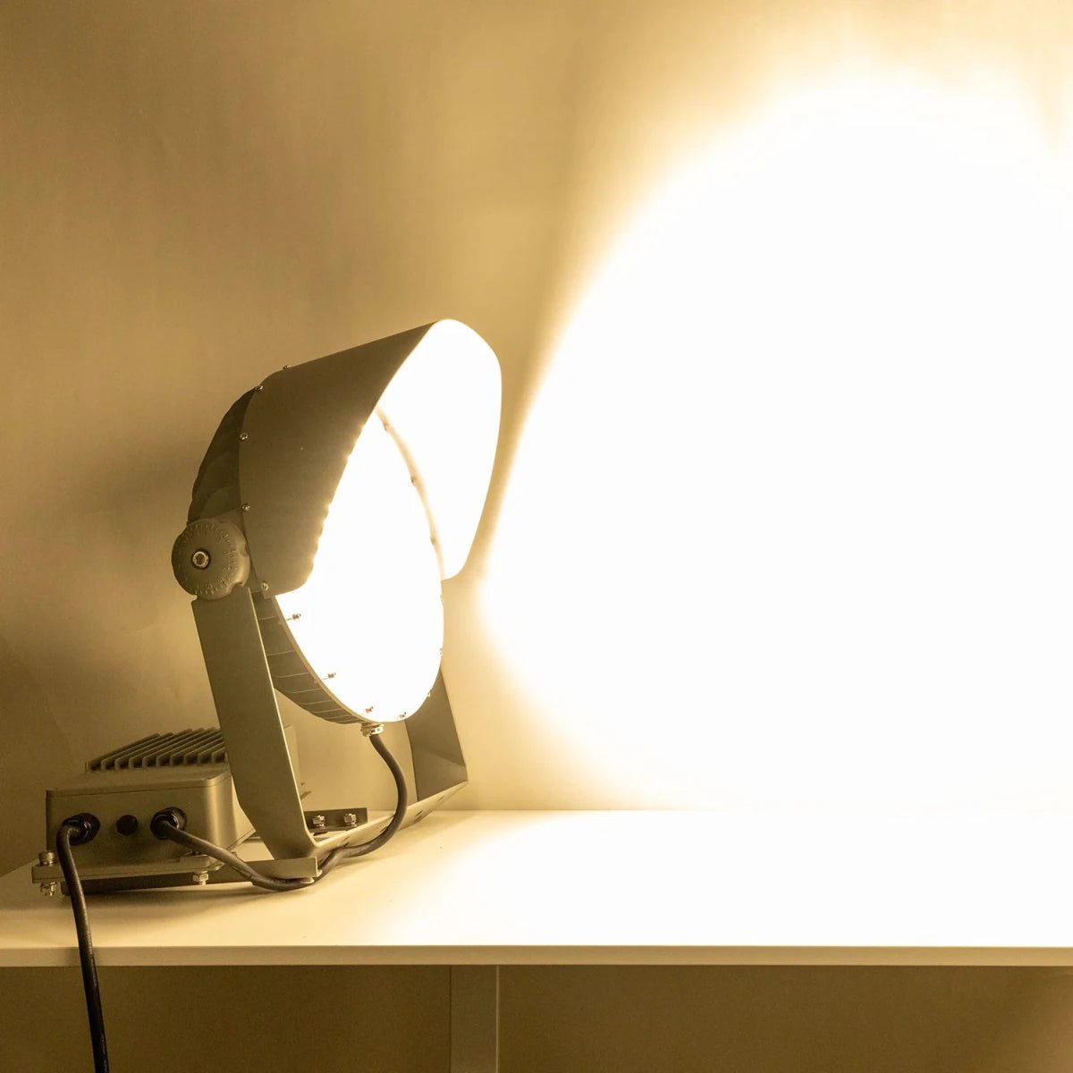 Light fixture on a white surface with a warm glow