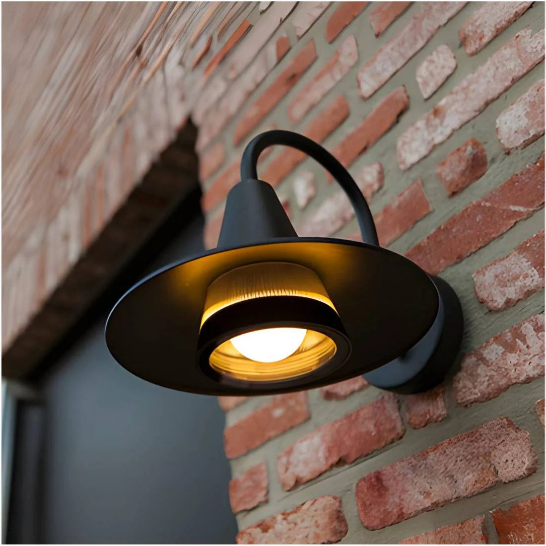Wall-mounted outdoor light fixture on a brick wall