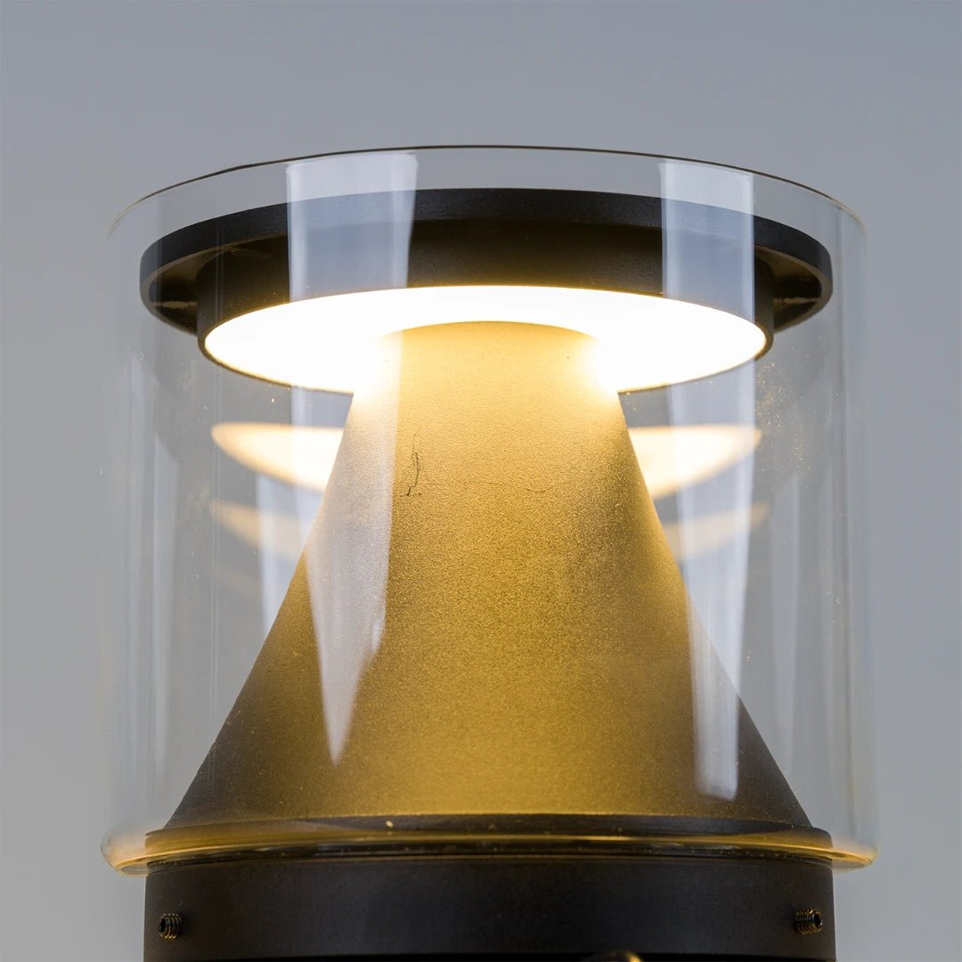 Ceiling light fixture with gold cone and clear glass cover on a gray background