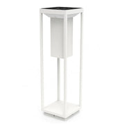 White plant stand with black top on a white background