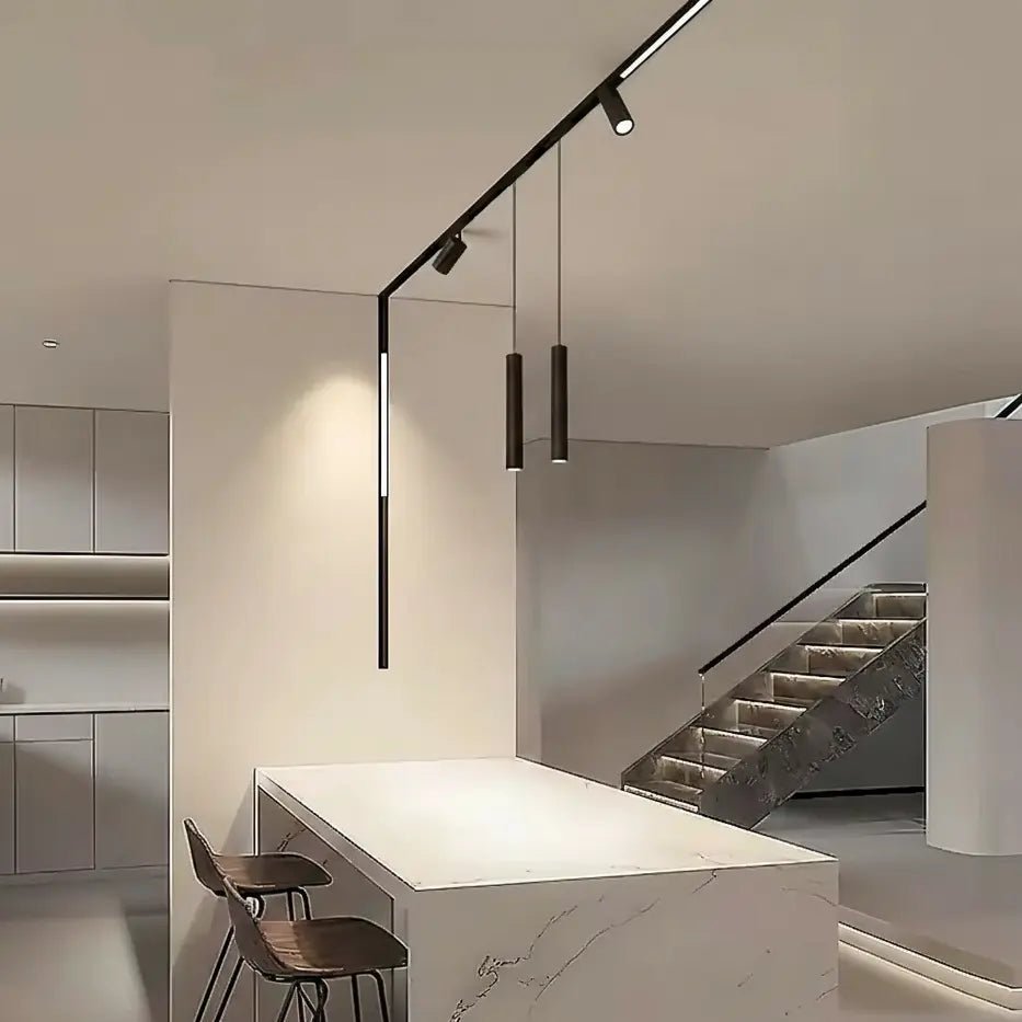 Modern interior with a kitchen island, chairs, and a staircase.