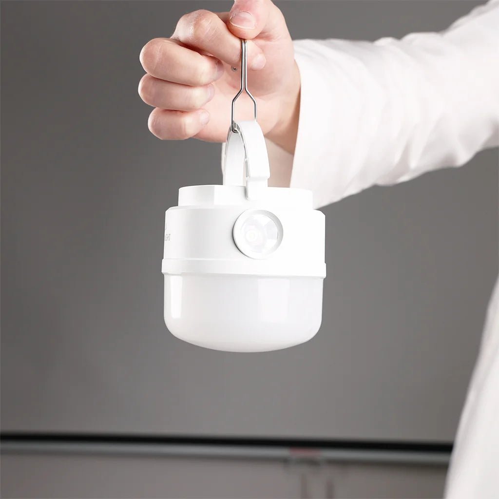 White container with a spoon being used on a gray background